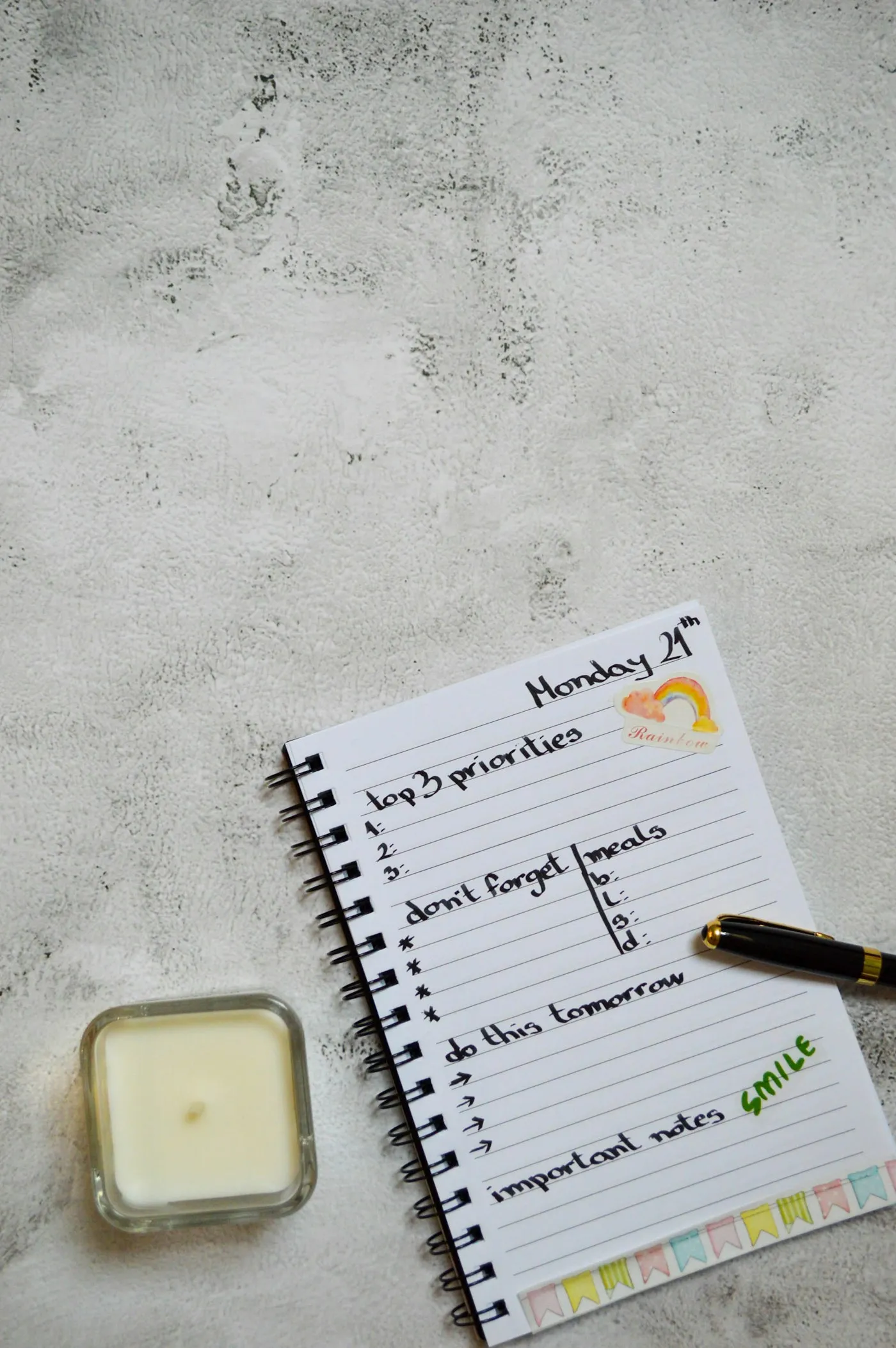 Event planning materials, notebook, and pen arranged on a table.
